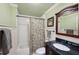 Bathroom with vanity, shower, and tub combination with decorative wainscoting at 1275 Smokehouse Trl, Cumming, GA 30041