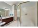 A full bathroom with a glass enclosed shower and a vanity with a dark wood cabinet at 1275 Smokehouse Trl, Cumming, GA 30041