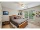 Cozy bedroom featuring a ceiling fan and natural light from the window at 1275 Smokehouse Trl, Cumming, GA 30041