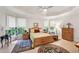 Bright bedroom with a tray ceiling, large windows, and hardwood floors at 1275 Smokehouse Trl, Cumming, GA 30041