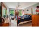 Well-lit bedroom with hardwood floors, a ceiling fan, and window views at 1275 Smokehouse Trl, Cumming, GA 30041
