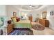 Bedroom featuring a tray ceiling, hardwood floors, and multiple windows at 1275 Smokehouse Trl, Cumming, GA 30041