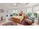 Comfortable bedroom with hardwood floors, large windows, and a seating area at 1275 Smokehouse Trl, Cumming, GA 30041