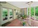Charming covered patio with brick flooring, seating, and plant decor, perfect for outdoor relaxation and entertaining at 1275 Smokehouse Trl, Cumming, GA 30041