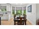 Dining area with a large bay window, featuring hardwood floors and a view of the backyard at 1275 Smokehouse Trl, Cumming, GA 30041