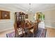 Warm dining room flows into the living area, featuring a china cabinet and stylish chairs at 1275 Smokehouse Trl, Cumming, GA 30041