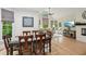 Eat-in kitchen dining area adjacent to the living area, featuring large windows and hardwood floors at 1275 Smokehouse Trl, Cumming, GA 30041