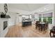 Spacious dining area with hardwood floors, fireplace, and adjacent kitchen with large windows and views at 1275 Smokehouse Trl, Cumming, GA 30041