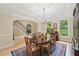 Formal dining room boasts hardwood floors, elegant chandelier, and large windows overlooking the lush greenery at 1275 Smokehouse Trl, Cumming, GA 30041