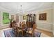 Charming dining room enhanced by natural light, custom trim, and stylish chandelier at 1275 Smokehouse Trl, Cumming, GA 30041