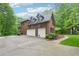 Spacious brick home with a two-car garage and a large driveway at 1275 Smokehouse Trl, Cumming, GA 30041