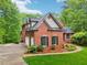 Charming brick home with a well-maintained lawn and three-car garage at 1275 Smokehouse Trl, Cumming, GA 30041