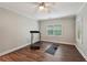 Home gym with ceiling fan, wood look floors, treadmill, yoga mat, and shoe rack at 1275 Smokehouse Trl, Cumming, GA 30041
