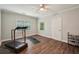 Home gym with ceiling fan, wood look floors, treadmill, yoga mat, and shoe rack at 1275 Smokehouse Trl, Cumming, GA 30041