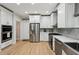 Modern kitchen with white cabinets, stainless steel appliances, and granite countertops at 1275 Smokehouse Trl, Cumming, GA 30041