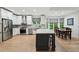Eat-in kitchen featuring stainless steel appliances, white cabinetry, tile backsplash and adjacent dining area at 1275 Smokehouse Trl, Cumming, GA 30041