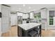 Bright eat-in kitchen with white cabinets, marble countertops, stainless steel appliances, and an island at 1275 Smokehouse Trl, Cumming, GA 30041