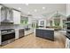 Open concept kitchen with stainless steel appliances, large island and an adjoining living space at 1275 Smokehouse Trl, Cumming, GA 30041