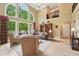 Bright living room features soaring windows, hardwood floors, and a cozy seating arrangement at 1275 Smokehouse Trl, Cumming, GA 30041