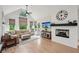 Inviting living room with a fireplace, comfortable seating, and large windows at 1275 Smokehouse Trl, Cumming, GA 30041