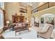 Open-concept living room with a loft area above, flowing into the dining area at 1275 Smokehouse Trl, Cumming, GA 30041