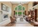 Elegant living room with fireplace, large windows offering a view, and comfortable seating at 1275 Smokehouse Trl, Cumming, GA 30041