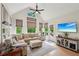 Cozy living room featuring large windows, a comfortable sectional, and vaulted ceiling at 1275 Smokehouse Trl, Cumming, GA 30041