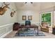 Home office with wainscoting, natural light, neutral colors, and hardwood flooring at 1275 Smokehouse Trl, Cumming, GA 30041