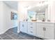 Bright bathroom featuring double vanity with white cabinets and black hardware and decorative mirror at 1712 Fulmont Cir, Mableton, GA 30126