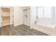 Luxurious bathroom with soaking tub, a glass-enclosed shower, and a large walk-in closet at 1712 Fulmont Cir, Mableton, GA 30126