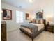 Cozy bedroom with neutral colors, decorative pillows, and natural light from the window at 1712 Fulmont Cir, Mableton, GA 30126
