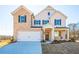 Charming two-story home featuring a brick and siding exterior with a two-car garage at 1712 Fulmont Cir, Mableton, GA 30126