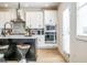 Kitchen features stainless steel appliances, an island with barstool seating, and pendant lighting at 1712 Fulmont Cir, Mableton, GA 30126