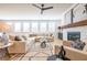Bright living room features fireplace, large windows, neutral color palette and stylish decor at 1712 Fulmont Cir, Mableton, GA 30126