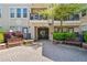 Exterior view of a building with a brick walkway, benches, and mature landscaping at 1850 Cotillion Dr # 3114, Atlanta, GA 30338