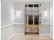 Elevator with mirrored doors in a hallway with wood floors and gray walls at 1850 Cotillion Dr # 3114, Atlanta, GA 30338