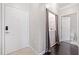 Hallway with a laundry area tucked behind a curtain and a full bathroom in the background at 1850 Cotillion Dr # 3114, Atlanta, GA 30338