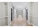 Long hallway with wood floors, gray walls, white trim, and apartment doors at 1850 Cotillion Dr # 3114, Atlanta, GA 30338