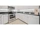 Well-lit kitchen with stainless steel oven, white cabinets, and modern appliances at 1850 Cotillion Dr # 3114, Atlanta, GA 30338
