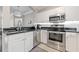 Modern kitchen with stainless steel appliances, white cabinets, and dark countertops at 1850 Cotillion Dr # 3114, Atlanta, GA 30338