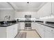 Modern kitchen featuring white cabinets, stainless steel appliances, and dark countertops at 1850 Cotillion Dr # 3114, Atlanta, GA 30338