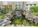 Beautiful rock waterfall feature flowing into the pond outside the property at 1850 Cotillion Dr # 3114, Atlanta, GA 30338