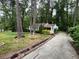 A picturesque view of a quaint home surrounded by lush greenery and tall trees at 1962 Clairmont Ter, Atlanta, GA 30345