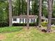 A charming home nestled among mature trees and verdant landscaping at 1962 Clairmont Ter, Atlanta, GA 30345