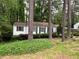 Cozy home exterior framed by mature trees and lush, green landscaping at 1962 Clairmont Ter, Atlanta, GA 30345