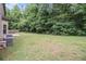 Expansive backyard featuring a lush lawn and mature trees for privacy at 3225 Rex Ridge Dr, Rex, GA 30273