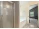 Bathroom area featuring a glass-enclosed shower and a soaking tub at 3225 Rex Ridge Dr, Rex, GA 30273