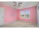 Bedroom featuring carpet, window, ceiling fan and pink walls at 3225 Rex Ridge Dr, Rex, GA 30273