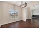 Well-lit dining room featuring modern lighting, hardwood floors, and a view of the neighborhood at 3225 Rex Ridge Dr, Rex, GA 30273