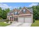 Attractive brick-front home with a two-car garage, neat landscaping and inviting curb appeal at 3225 Rex Ridge Dr, Rex, GA 30273